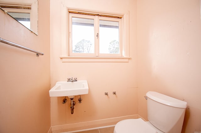 bathroom with tile patterned flooring, toilet, and sink