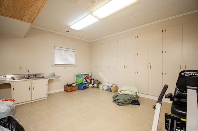 interior space featuring crown molding, sink, and light tile patterned flooring