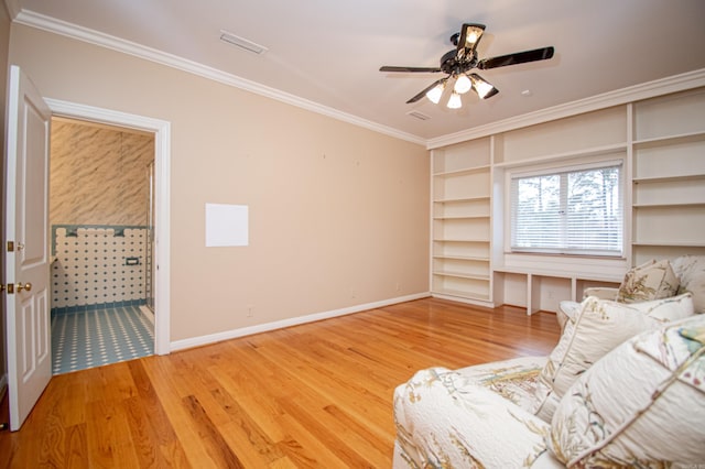 unfurnished room with hardwood / wood-style flooring, ceiling fan, and ornamental molding