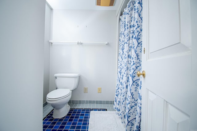 bathroom featuring toilet and tile patterned floors