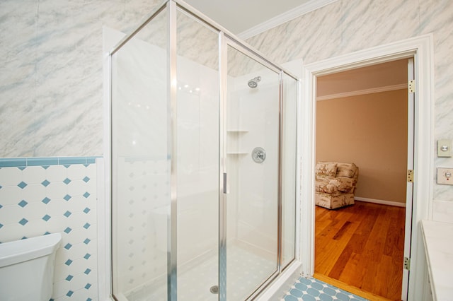 bathroom with a shower with door and ornamental molding