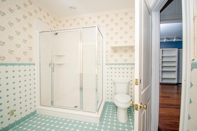 bathroom featuring toilet, ornamental molding, and walk in shower