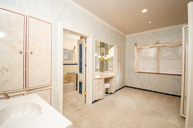 bathroom featuring a bathing tub, vanity, and ornamental molding