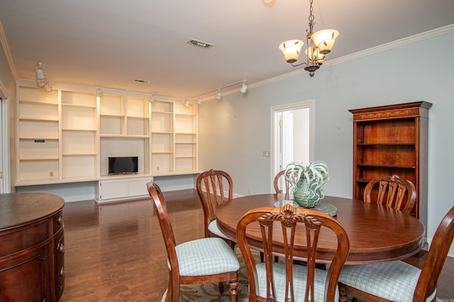 dining space featuring dark wood-type flooring, an inviting chandelier, and crown molding