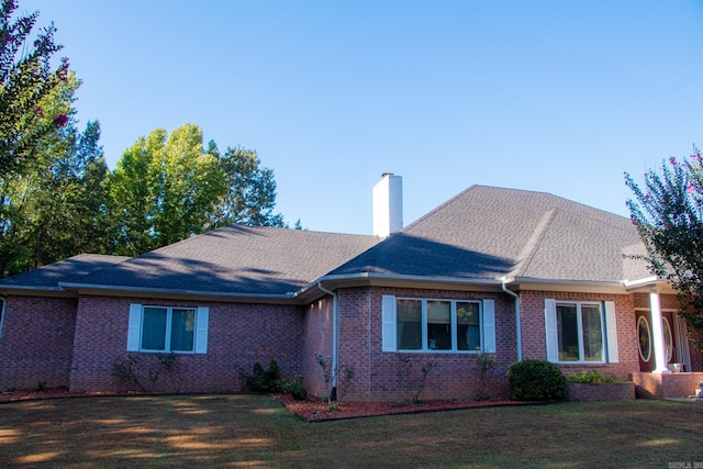 view of side of property with a lawn