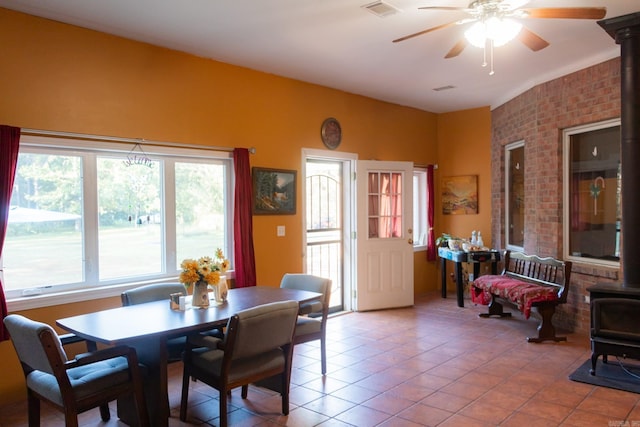 tiled dining space featuring ceiling fan and a wealth of natural light