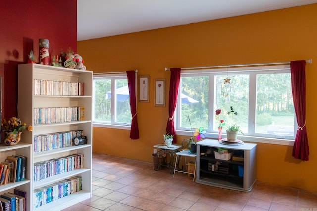 sitting room with a healthy amount of sunlight and light tile patterned flooring