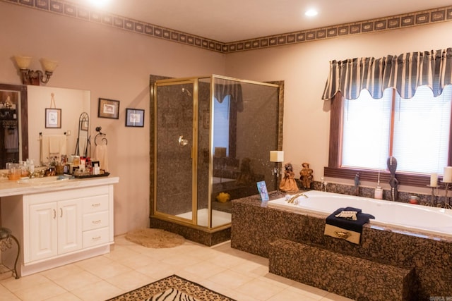 bathroom with tile patterned floors, vanity, and separate shower and tub