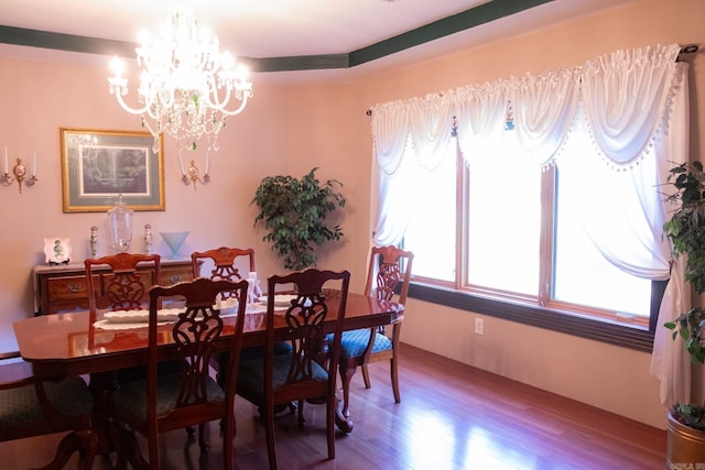 dining area featuring hardwood / wood-style floors and a chandelier