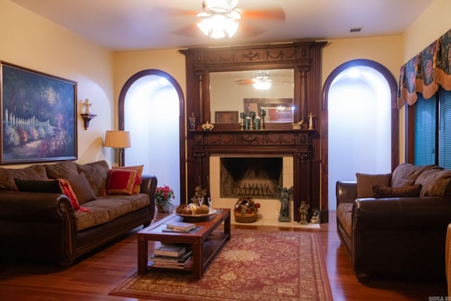 living room featuring hardwood / wood-style flooring and a large fireplace