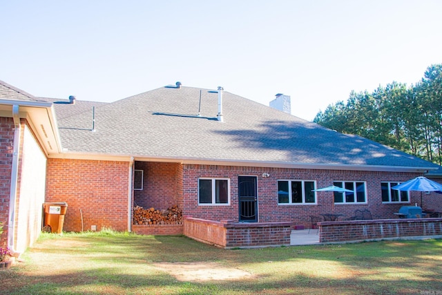 rear view of property featuring a yard