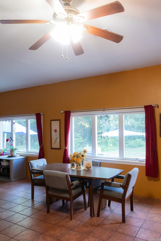 tiled dining space with ceiling fan