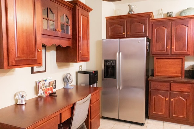 kitchen featuring light tile patterned floors and stainless steel refrigerator with ice dispenser