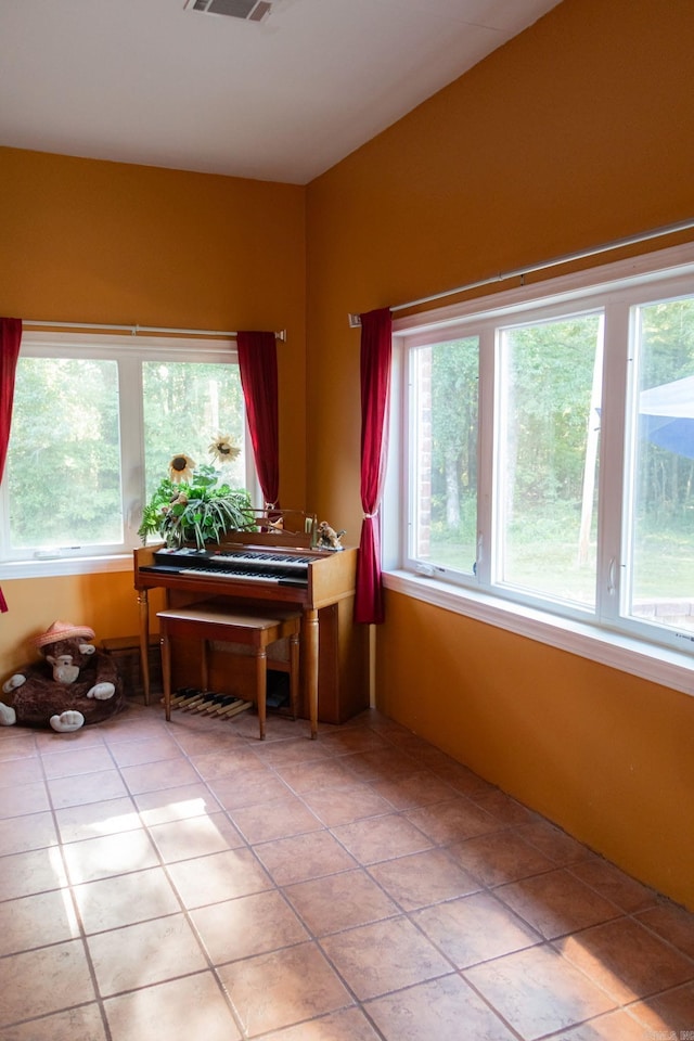 interior space with tile patterned floors and plenty of natural light