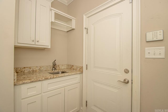 interior space featuring crown molding and sink