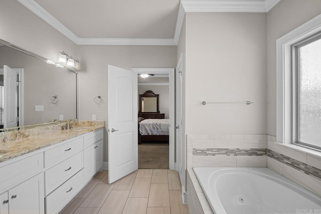 bathroom featuring vanity, crown molding, plenty of natural light, and a relaxing tiled tub