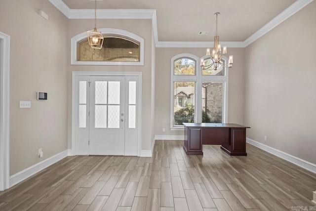 entryway featuring hardwood / wood-style flooring, crown molding, and an inviting chandelier