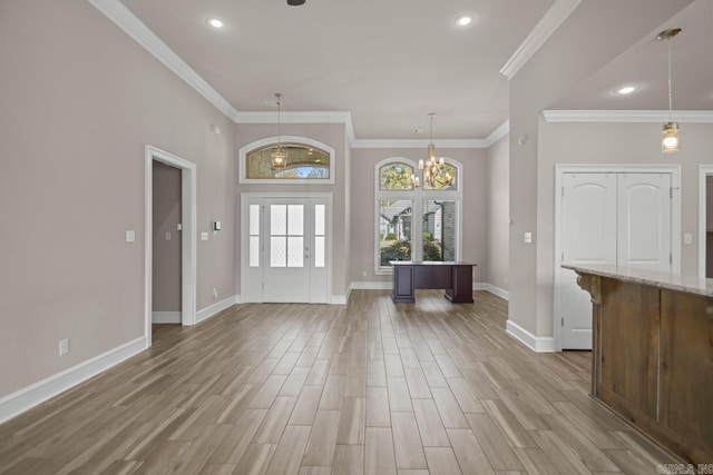 entrance foyer with crown molding and an inviting chandelier