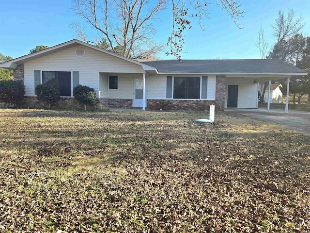 ranch-style home with a carport and a front lawn