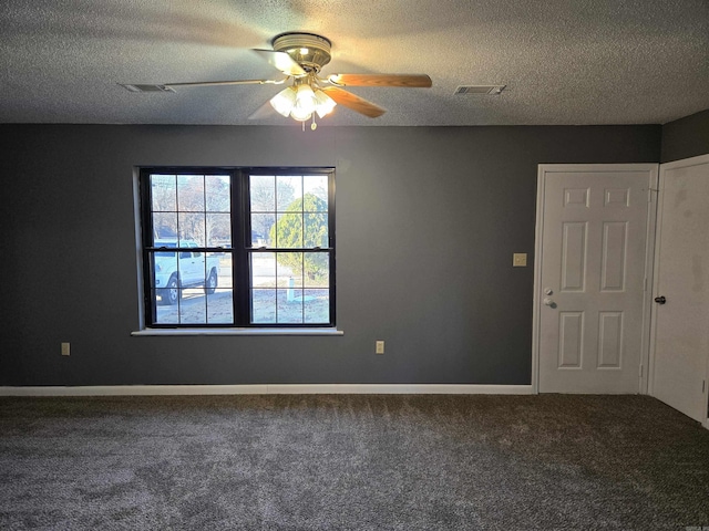 empty room with ceiling fan, carpet floors, and a textured ceiling