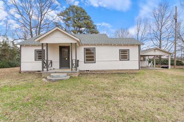 view of front of house with a front yard and a carport