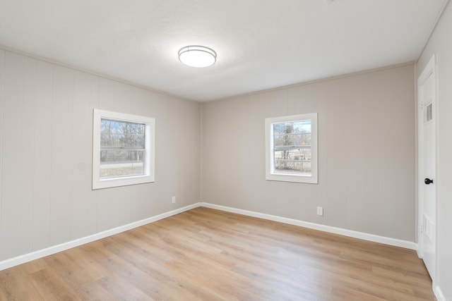 unfurnished room featuring plenty of natural light and light hardwood / wood-style flooring