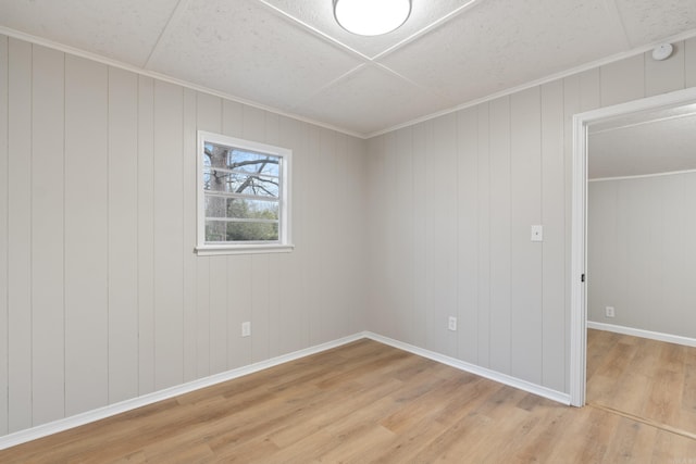 unfurnished bedroom featuring ornamental molding and light hardwood / wood-style flooring