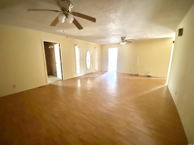 unfurnished room with ceiling fan and light hardwood / wood-style flooring