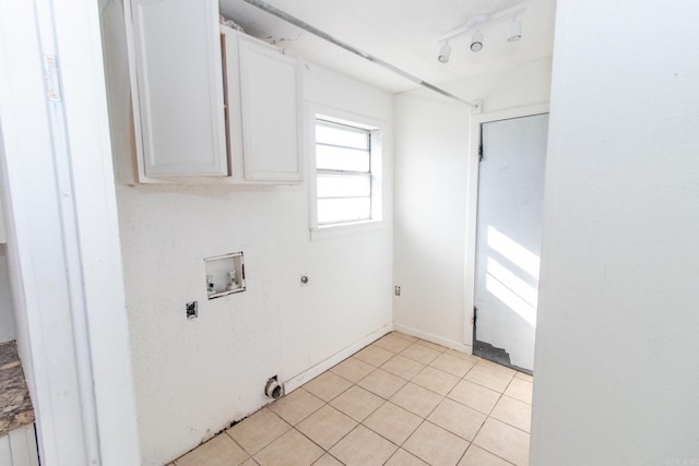 washroom featuring cabinets, hookup for a washing machine, gas dryer hookup, electric dryer hookup, and light tile patterned floors