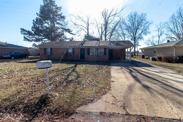 single story home featuring a carport and central AC