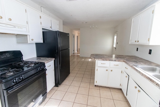 kitchen with white cabinets, light tile patterned floors, extractor fan, and black appliances