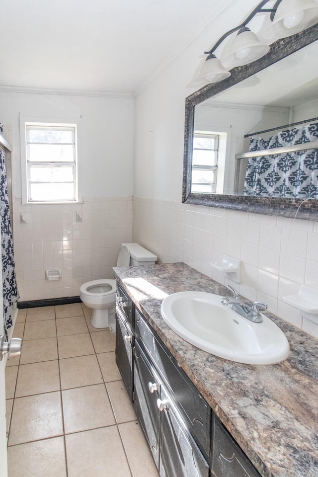 bathroom featuring tile patterned flooring, toilet, vanity, tile walls, and ornamental molding