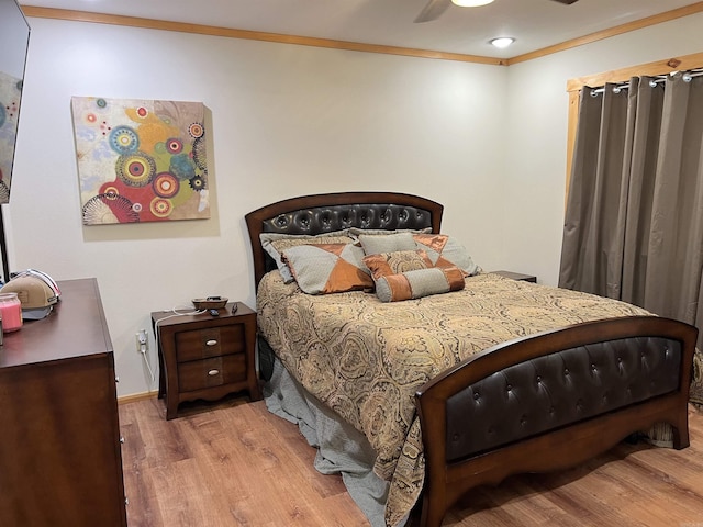 bedroom featuring ceiling fan, light hardwood / wood-style floors, and ornamental molding