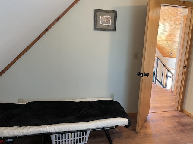 bedroom with hardwood / wood-style floors and wooden ceiling