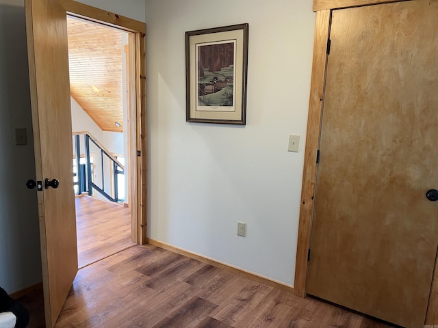 hall with hardwood / wood-style flooring and wood ceiling