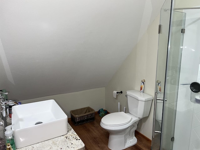 bathroom with walk in shower, sink, wood-type flooring, and toilet