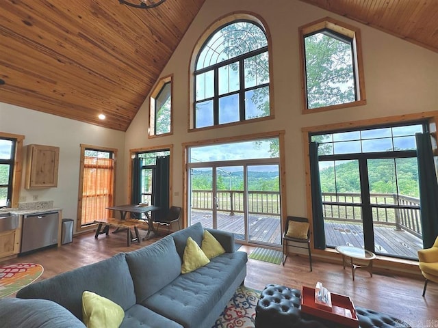 living room with a wealth of natural light, wooden ceiling, high vaulted ceiling, and wood-type flooring