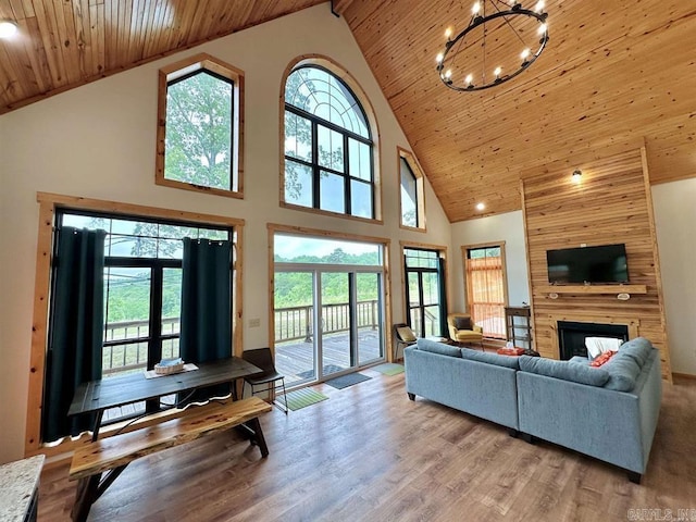 living room featuring beamed ceiling, light hardwood / wood-style flooring, high vaulted ceiling, and wooden ceiling