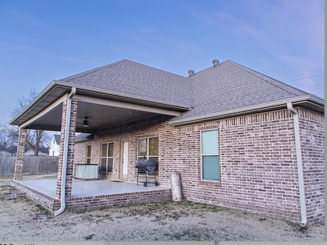 rear view of property featuring a patio and ceiling fan