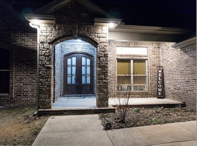 view of exterior entry featuring french doors