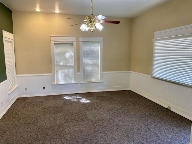 carpeted empty room featuring ceiling fan