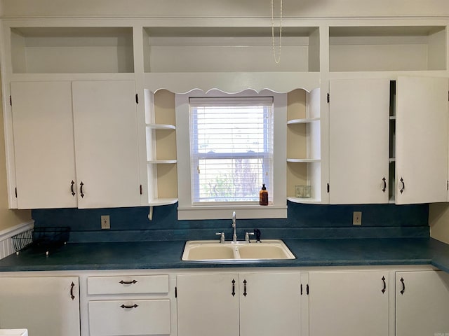 kitchen featuring white cabinetry and sink