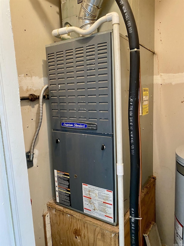 utility room featuring heating unit