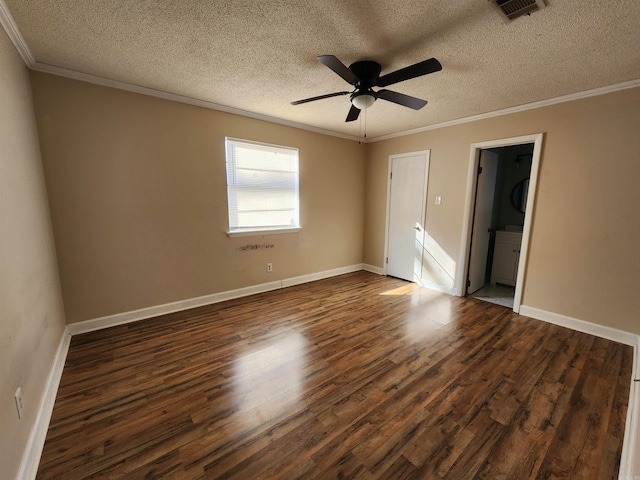 spare room with a textured ceiling, dark hardwood / wood-style floors, ceiling fan, and crown molding