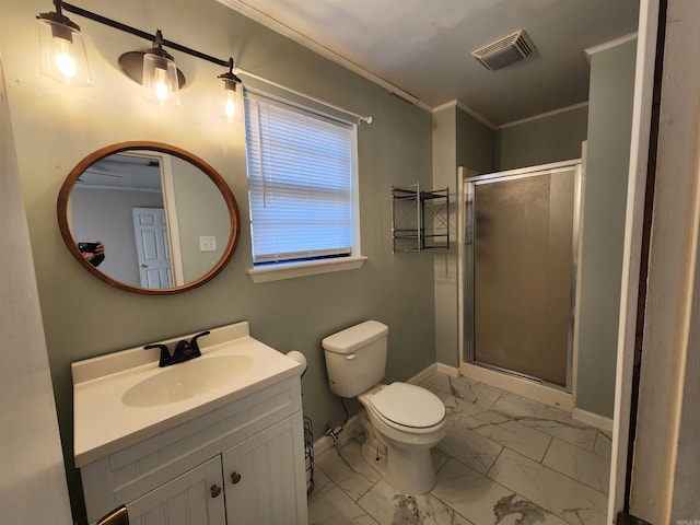 bathroom featuring vanity, toilet, a shower with shower door, and crown molding