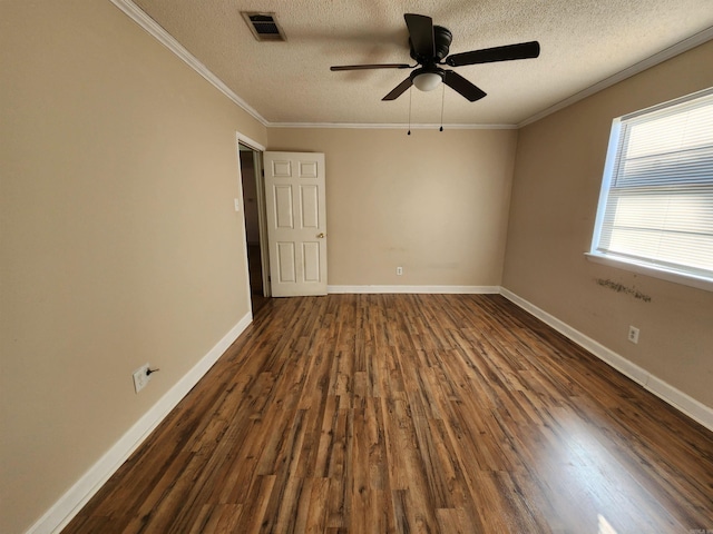 empty room featuring a textured ceiling, dark hardwood / wood-style flooring, ceiling fan, and crown molding