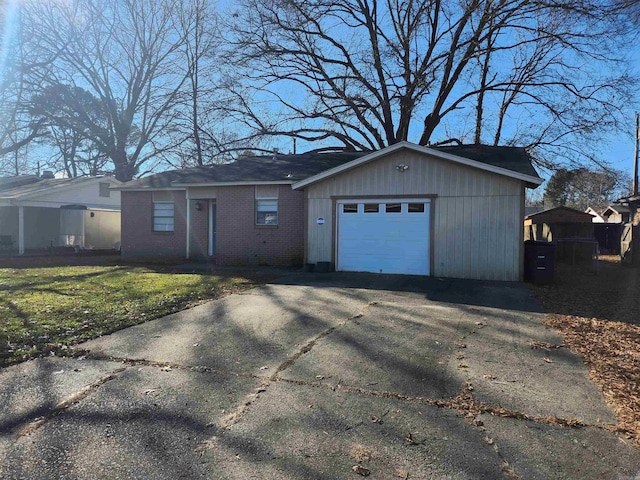 ranch-style house with a garage and a front yard