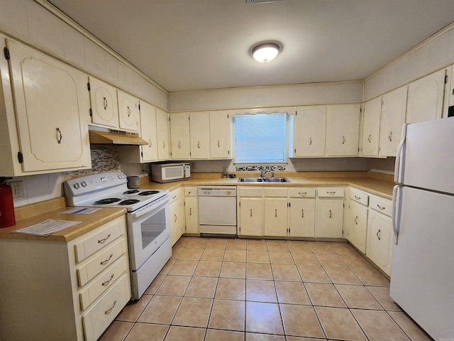 kitchen featuring white appliances, backsplash, sink, light tile patterned floors, and ornamental molding