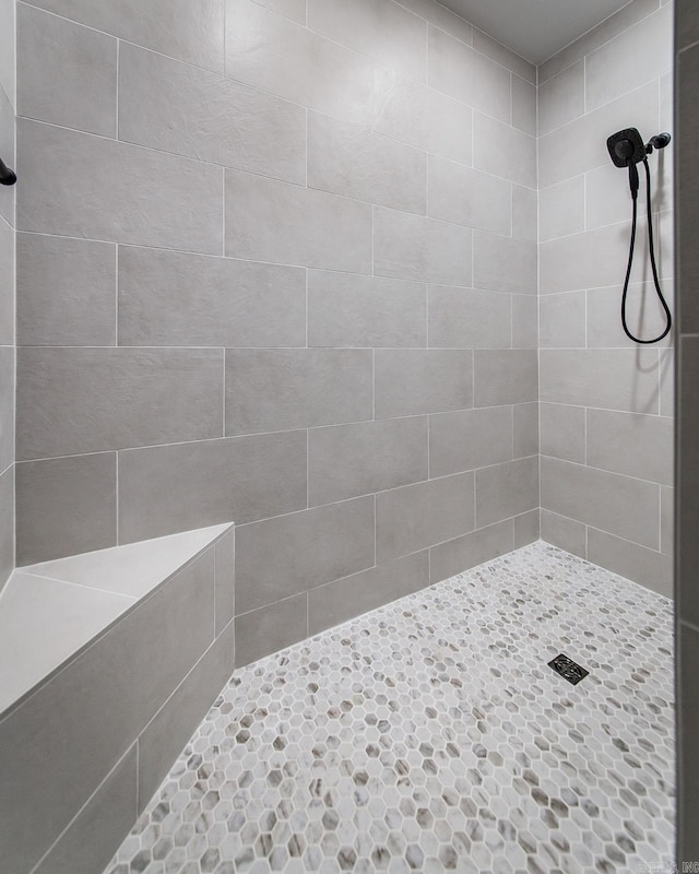 bathroom with a tile shower