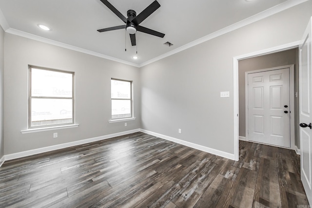 empty room featuring dark hardwood / wood-style flooring, ceiling fan, and ornamental molding